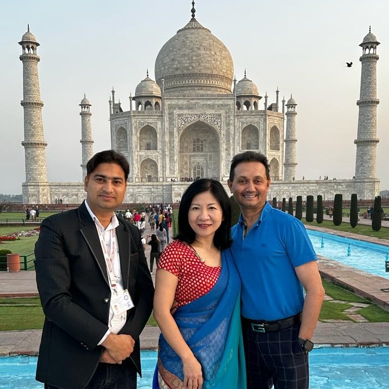 Wahid Khan, government approved tour guide, with travellers at the Taj Mahal in Agra